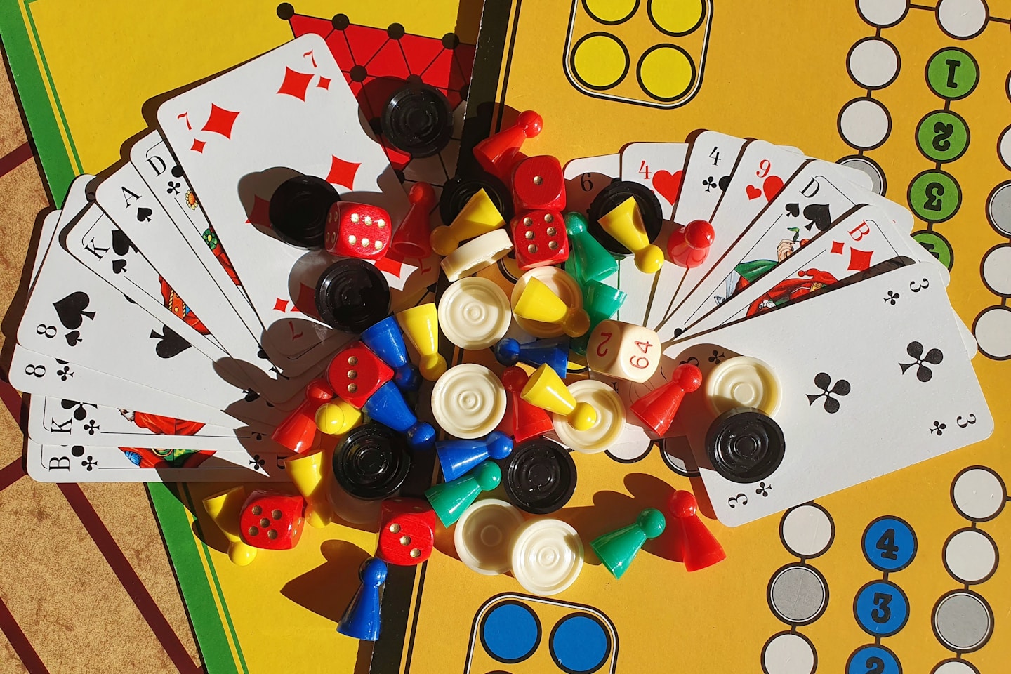 Various board games, game pieces, dices and playing cards