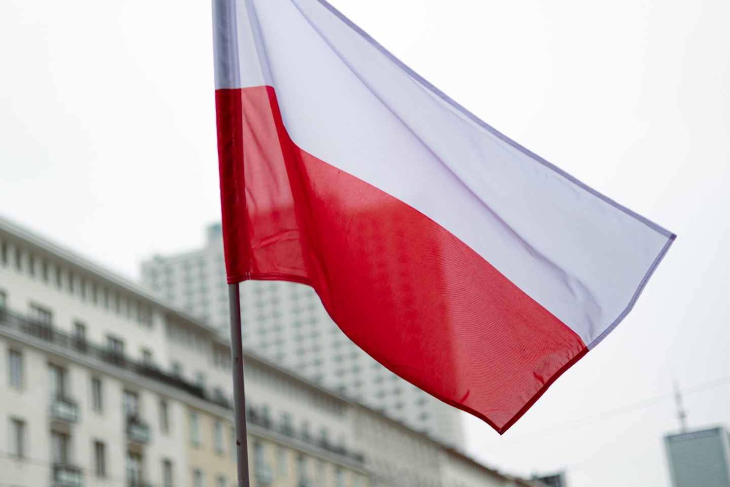 The polish flag waves in the breeze.